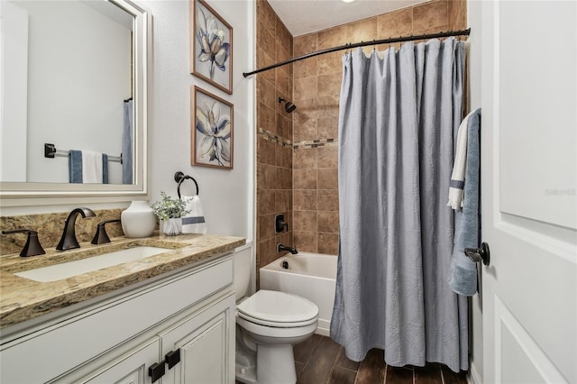 bathroom with vanity, toilet, shower / bath combo, and wood finish floors