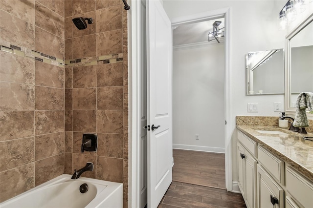 bathroom featuring baseboards, wood tiled floor, shower / tub combination, ornamental molding, and vanity