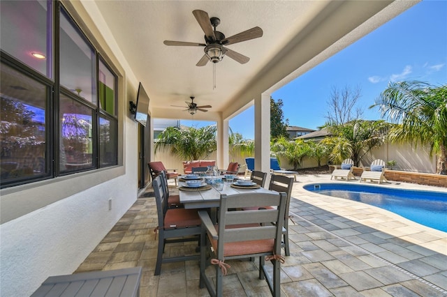 view of patio / terrace with outdoor dining area, a fenced in pool, a fenced backyard, and a ceiling fan