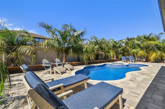 view of swimming pool with a patio, a fenced backyard, and a pool with connected hot tub