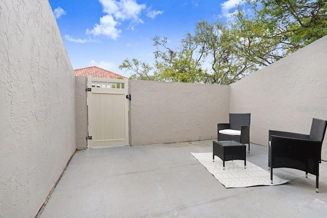 view of patio with a gate and fence