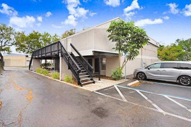 exterior space with uncovered parking and stairs