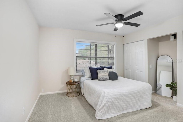 bedroom with carpet flooring, baseboards, and a closet