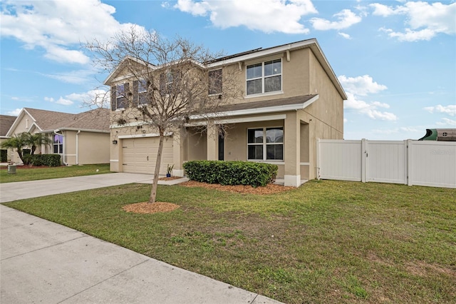 traditional-style home with stucco siding, a front lawn, driveway, and a gate