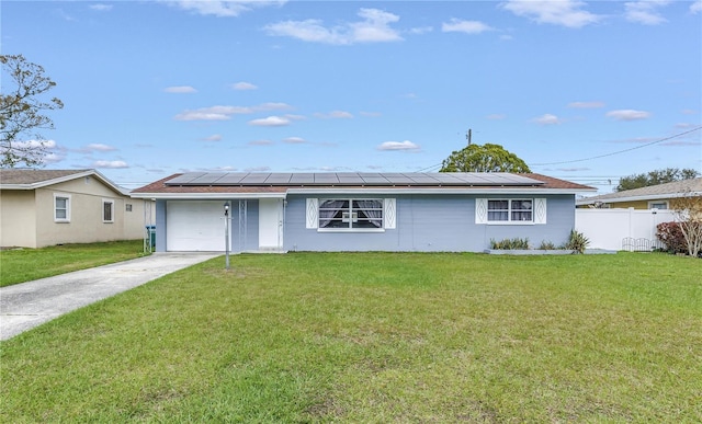 single story home with a front yard, fence, driveway, a garage, and roof mounted solar panels