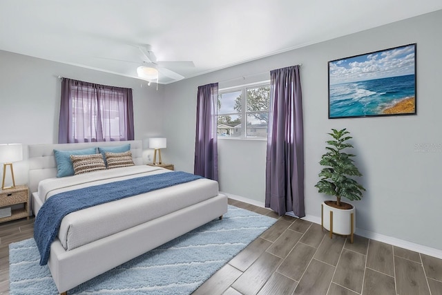 bedroom with wood finish floors, baseboards, and ceiling fan