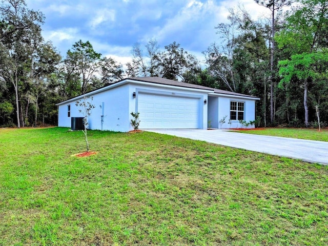 garage with central AC unit and driveway