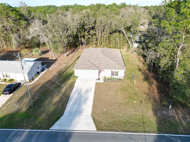 drone / aerial view featuring a view of trees