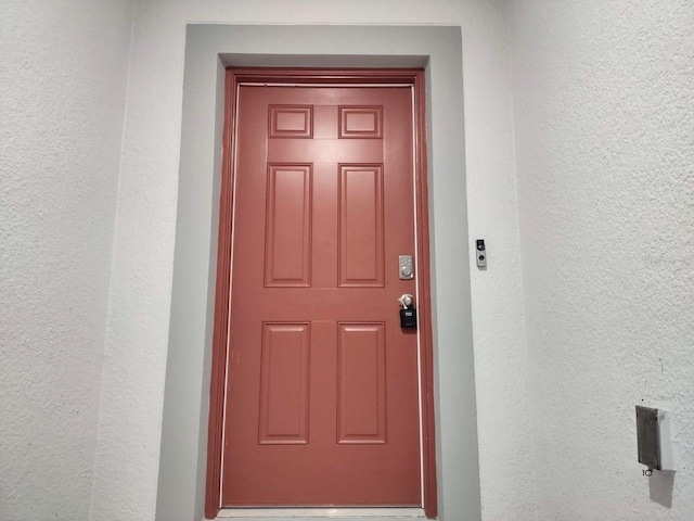 entrance to property featuring stucco siding