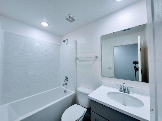 bathroom with washtub / shower combination, visible vents, toilet, and vanity