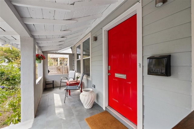 view of exterior entry with a porch