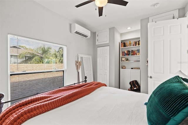 bedroom with an AC wall unit and a ceiling fan