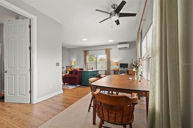 dining area with baseboards, ceiling fan, a wall mounted air conditioner, light wood-type flooring, and recessed lighting