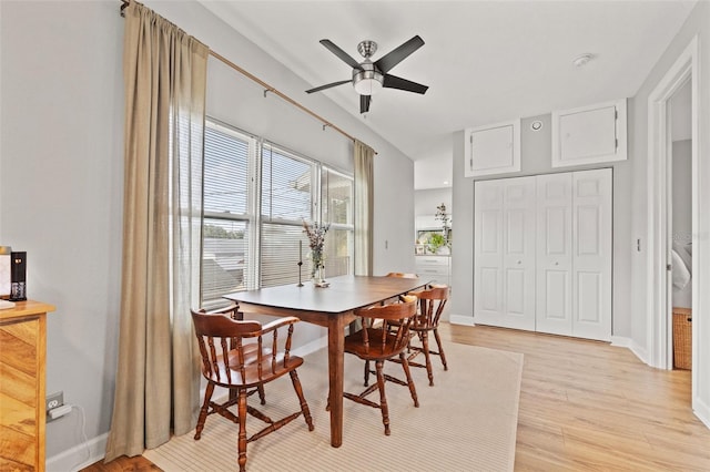 dining area with baseboards, ceiling fan, and light wood finished floors