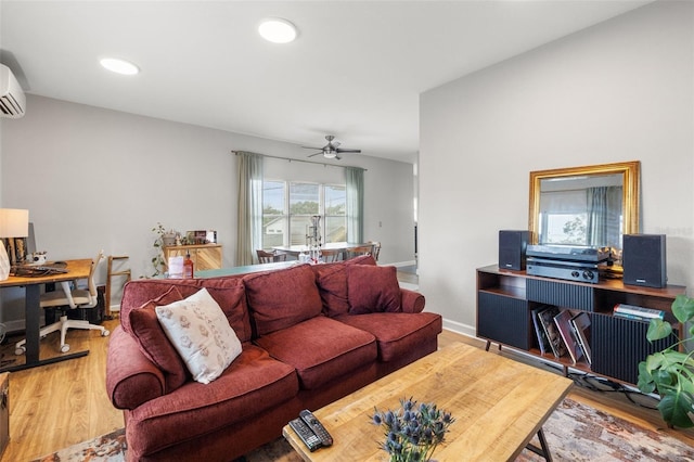 living room featuring wood finished floors, baseboards, a wall mounted AC, recessed lighting, and ceiling fan