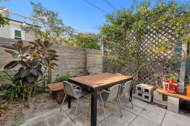 view of patio / terrace featuring outdoor dining area and fence