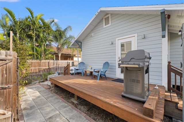 wooden terrace with grilling area and fence