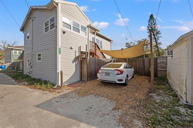 view of side of property featuring fence