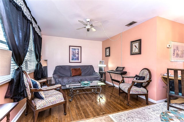 living room with visible vents, baseboards, a ceiling fan, and wood finished floors