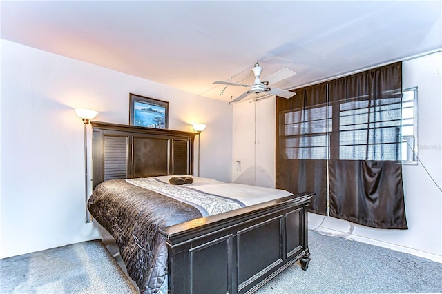 bedroom with light carpet and a ceiling fan