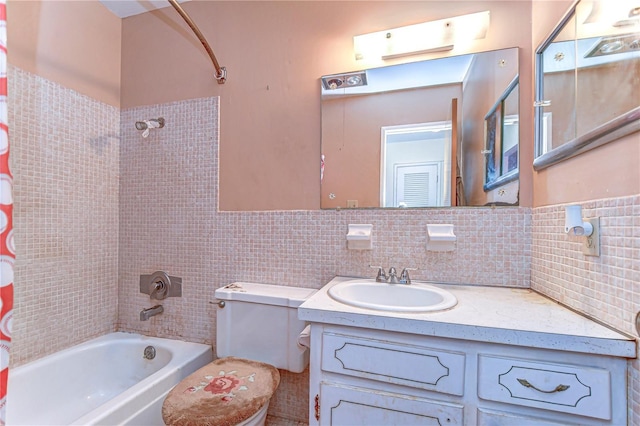 bathroom featuring tasteful backsplash, toilet, vanity, and shower / bath combo