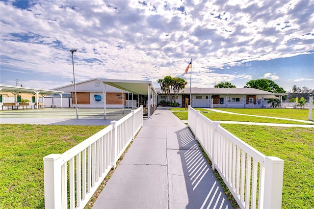 view of home's community featuring a lawn