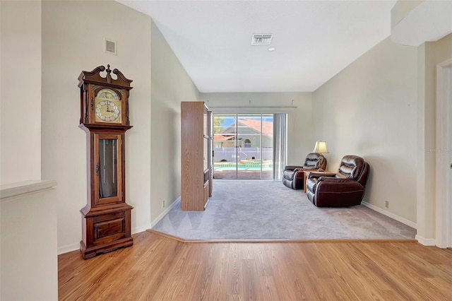 sitting room featuring wood finished floors, visible vents, and baseboards