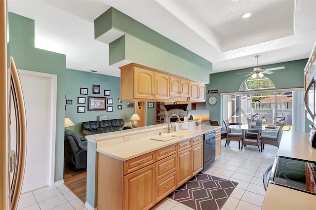 kitchen with light tile patterned floors, light brown cabinets, ceiling fan, a sink, and dishwasher