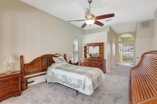 bedroom with connected bathroom, visible vents, carpet floors, and ceiling fan