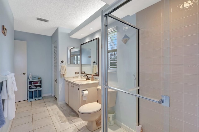 full bath featuring vanity, visible vents, a stall shower, tile patterned flooring, and a textured ceiling