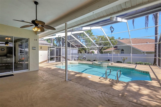 view of pool featuring a ceiling fan, a pool with connected hot tub, fence, glass enclosure, and a patio area