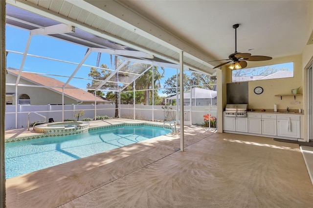 view of pool with exterior kitchen, area for grilling, fence, and a patio