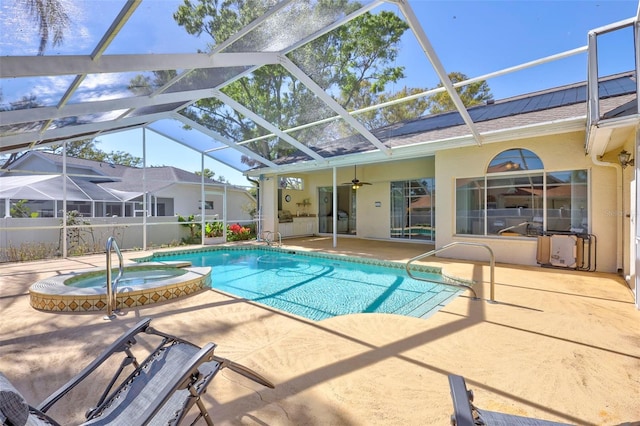 view of swimming pool featuring a lanai, a pool with connected hot tub, a patio, and a ceiling fan