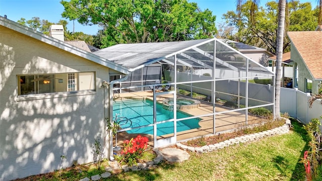 view of pool featuring a lanai, a pool with connected hot tub, a fenced backyard, and a patio area