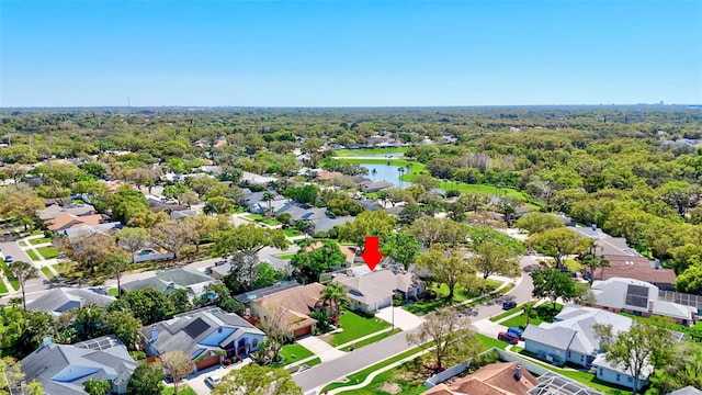 drone / aerial view featuring a residential view and a wooded view