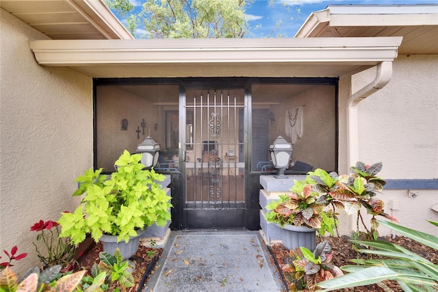 doorway to property featuring stucco siding