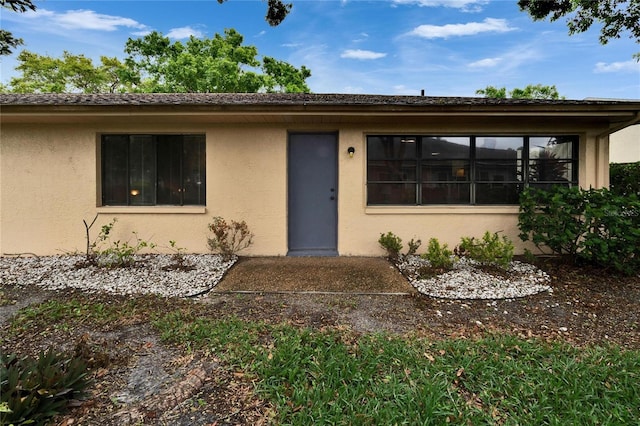 ranch-style house with stucco siding