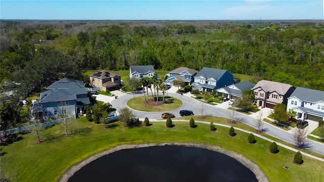 bird's eye view with a wooded view and a residential view