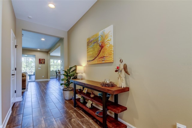 corridor with recessed lighting and baseboards