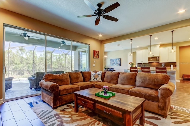 living area with recessed lighting, a healthy amount of sunlight, and a sunroom