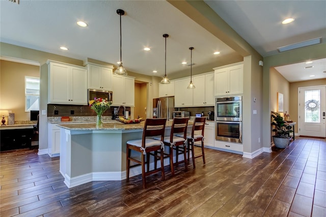 kitchen featuring dark wood-type flooring, tasteful backsplash, and stainless steel appliances