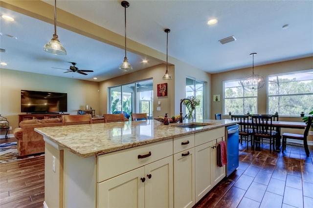 kitchen featuring dishwasher, wood finish floors, visible vents, and a sink