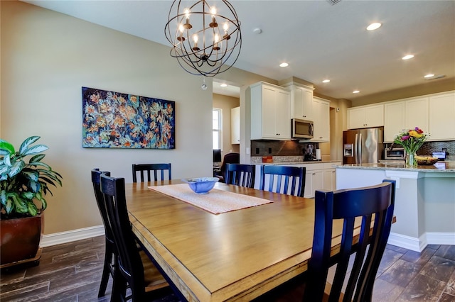 dining area featuring recessed lighting, a chandelier, baseboards, and dark wood finished floors