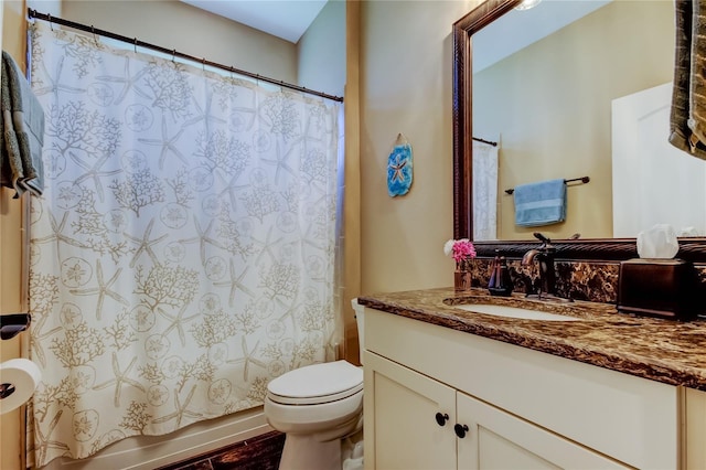 bathroom with vanity, shower / tub combo, and toilet