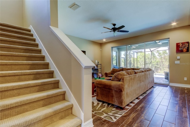 living room featuring visible vents, stairway, baseboards, and wood tiled floor