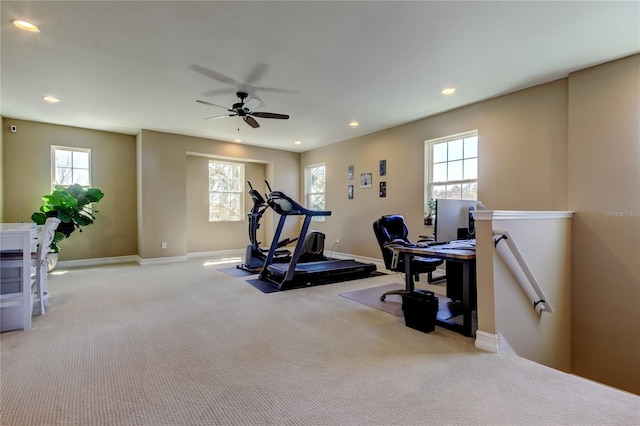 exercise room with recessed lighting, a healthy amount of sunlight, baseboards, and carpet