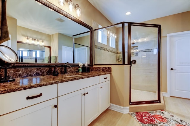 bathroom with visible vents, a shower stall, vanity, and wood finished floors