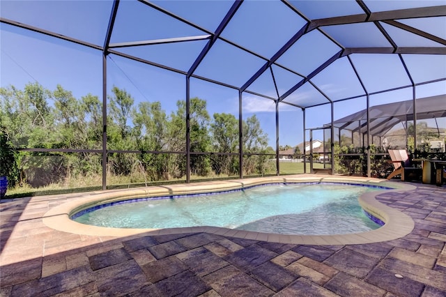 outdoor pool with a lanai and a patio area