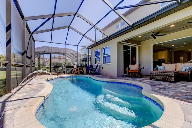 outdoor pool featuring a lanai, ceiling fan, outdoor lounge area, and a patio area