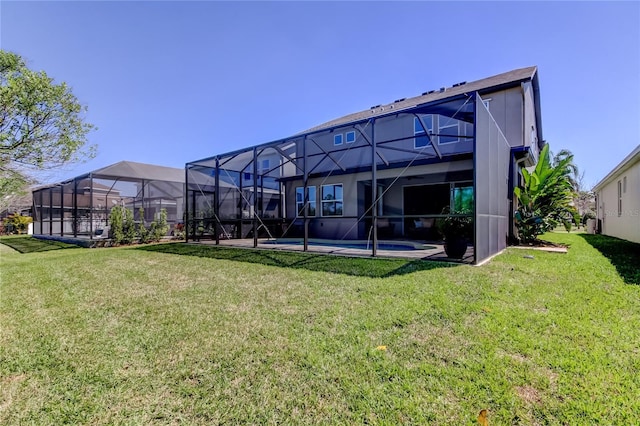 back of property featuring an outdoor pool, a lawn, and a lanai